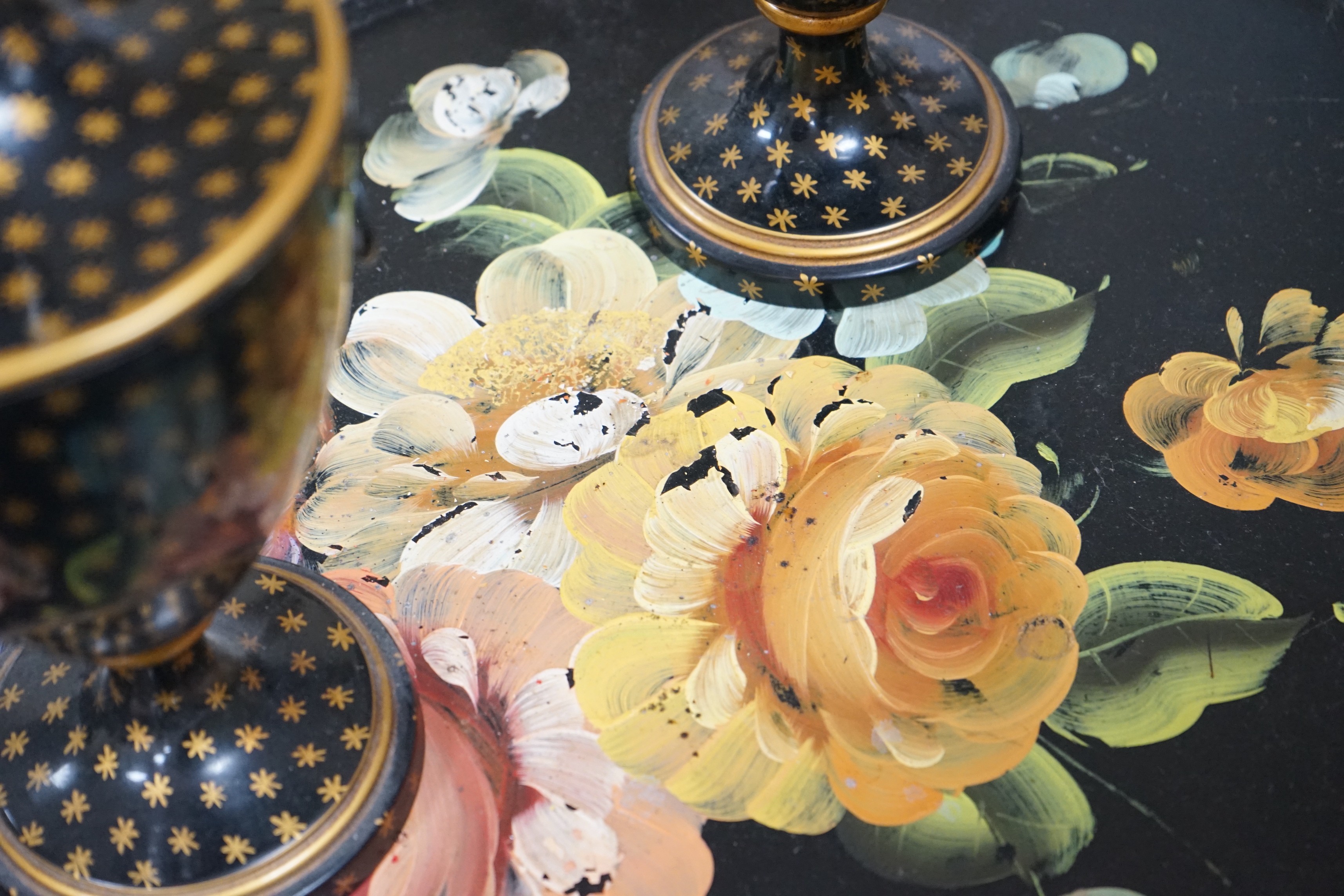 A pair of lidded painted toleware vessels, together with a painted tin toleware tray, 65cm long (3)